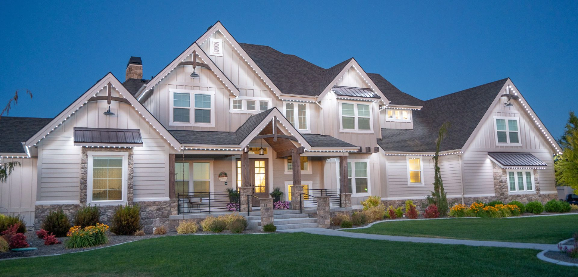 Twin Cities home at dusk with permanent roofline lighting